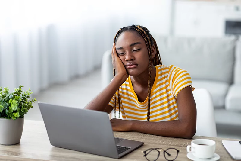 exhausted-african-american-woman-freelancer-sleepi-2022-12-16-08-18-24-utc